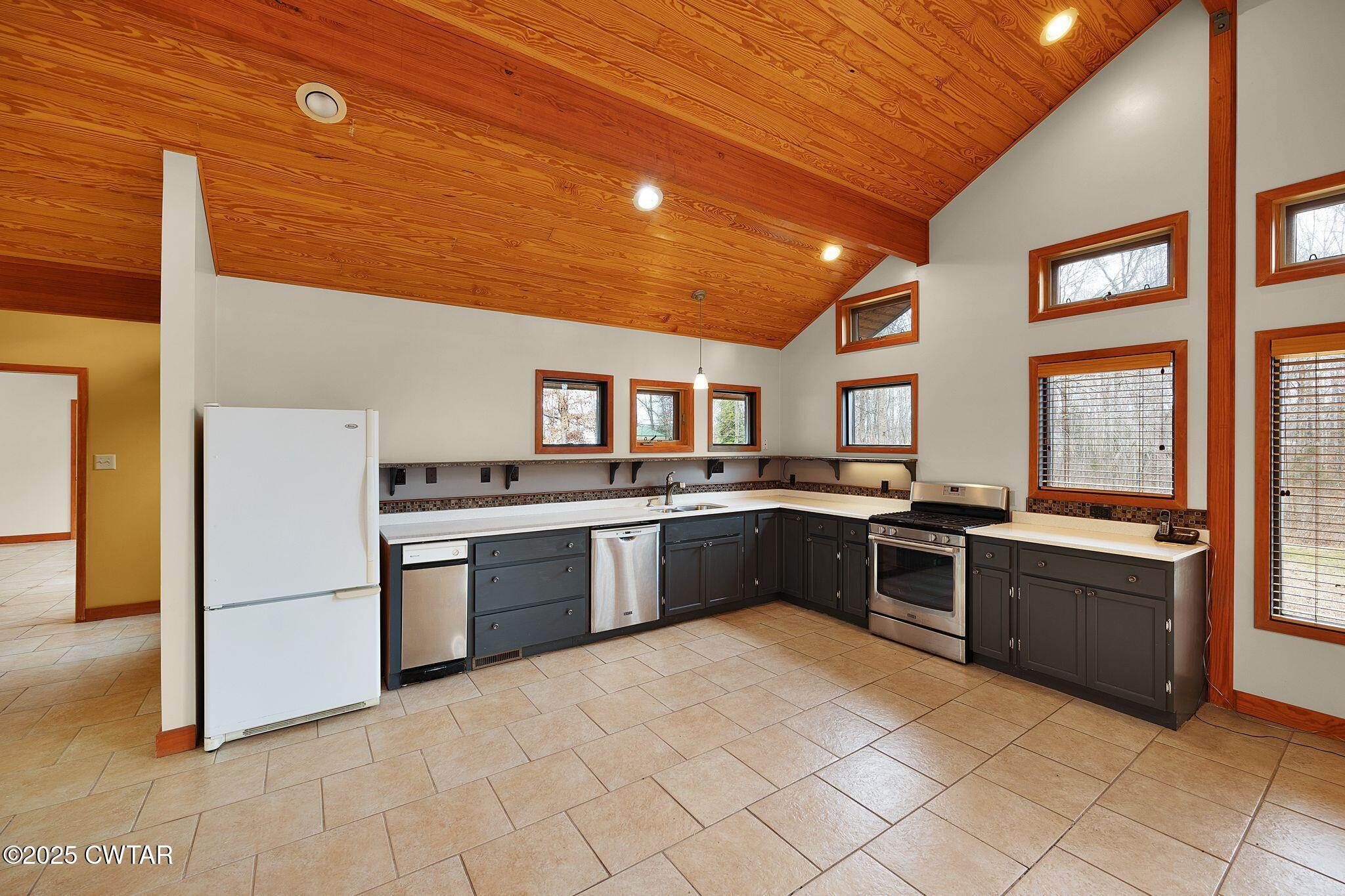 1273 Palmer Road Lexington, TN 38351 - Photo 16 of 62 a large kitchen with stainless steel appliances granite countertop a stove and a sink