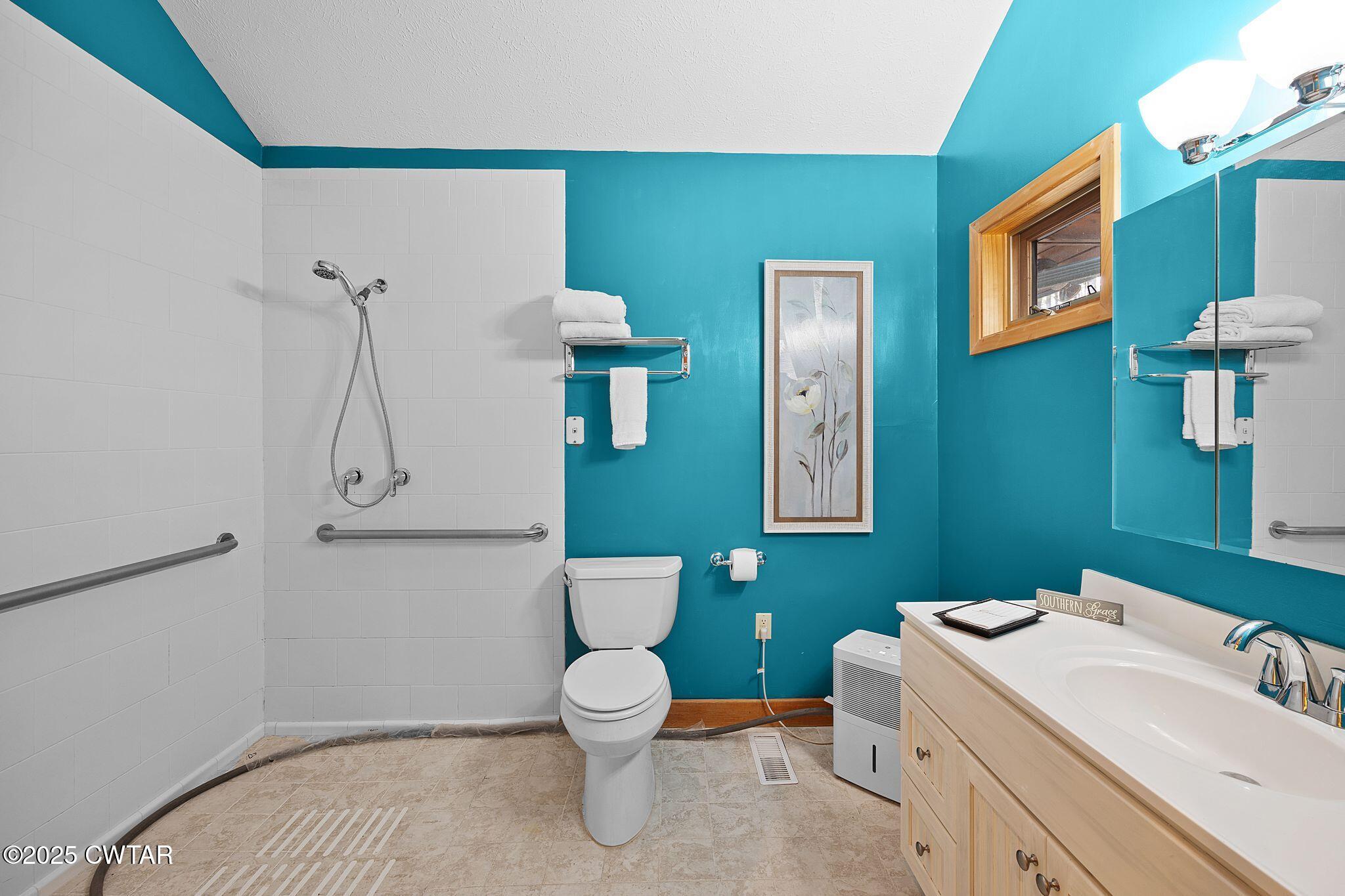 1273 Palmer Road Lexington, TN 38351 - Photo 26 of 62 a bathroom with a toilet sink and mirror