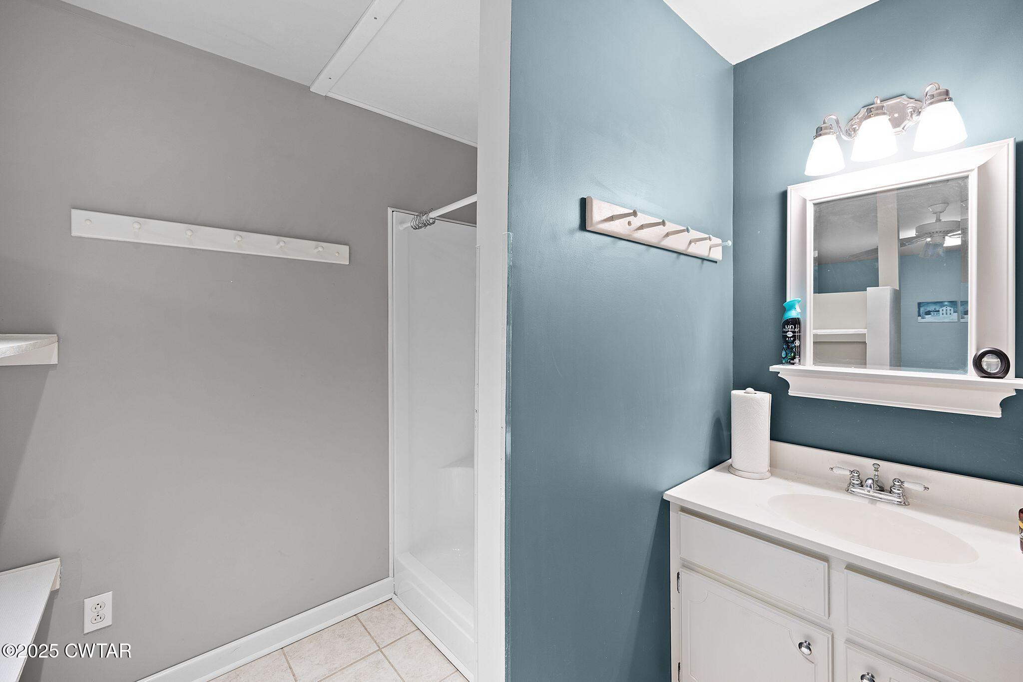 1273 Palmer Road Lexington, TN 38351 - Photo 51 of 62 a bathroom with a sink and a mirror