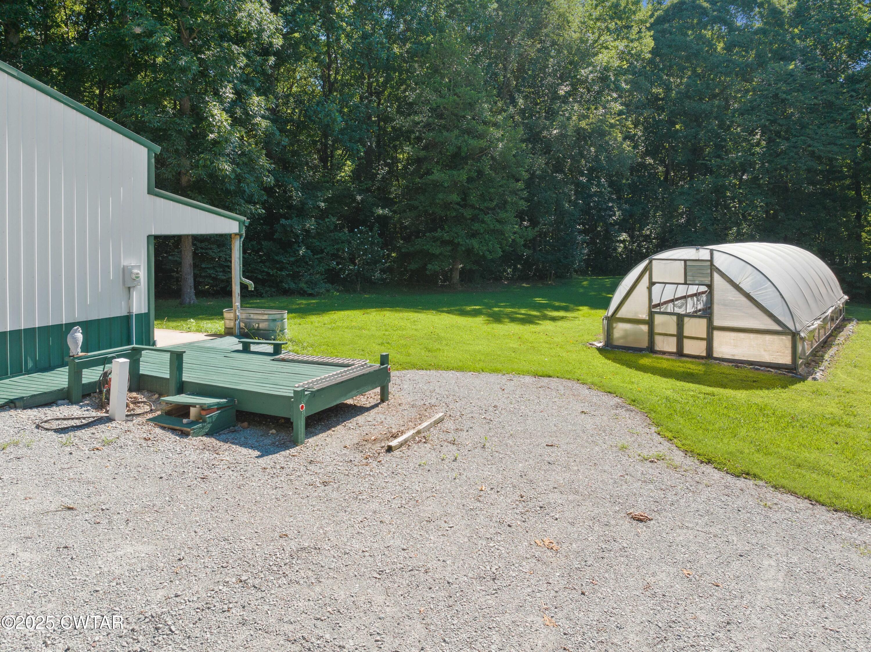 1273 Palmer Road Lexington, TN 38351 - Photo 6 of 62 a backyard of a house with table and chairs