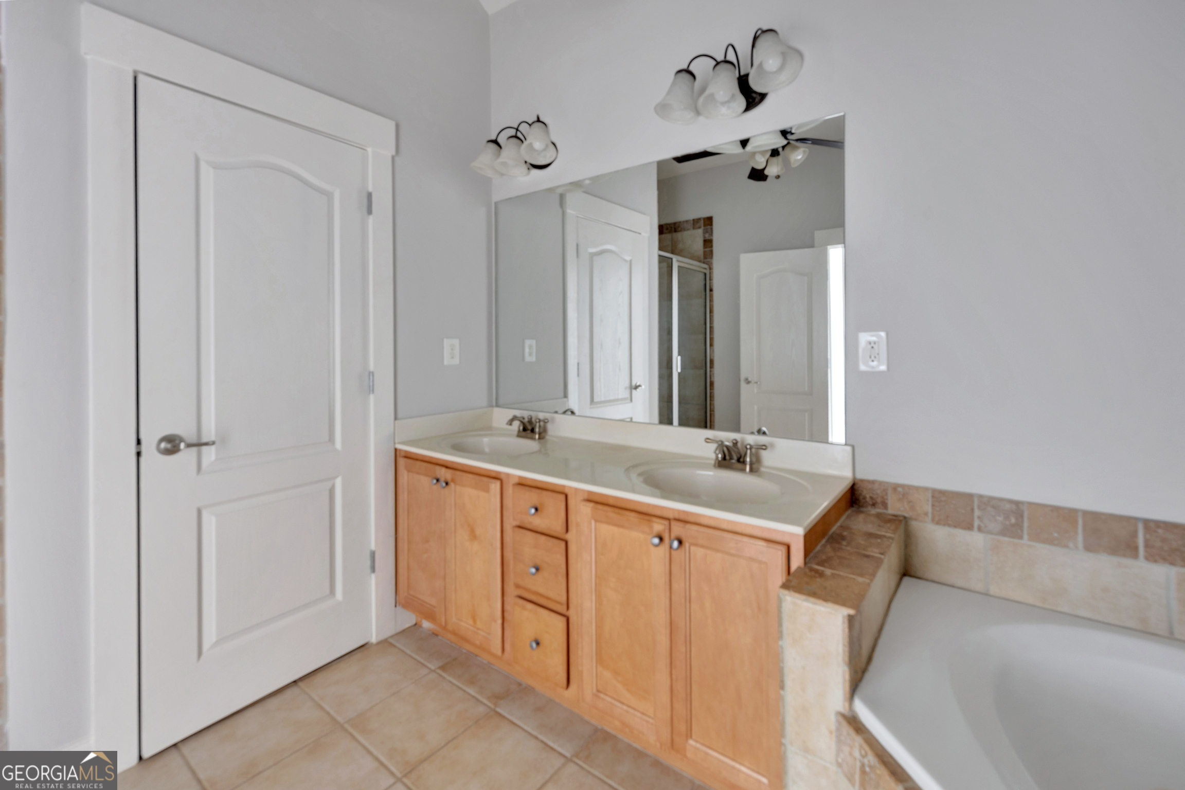 205 Ryan Lane Covington, GA 30014 - Photo 19 of 37 a bathroom with a tub sink and mirror
