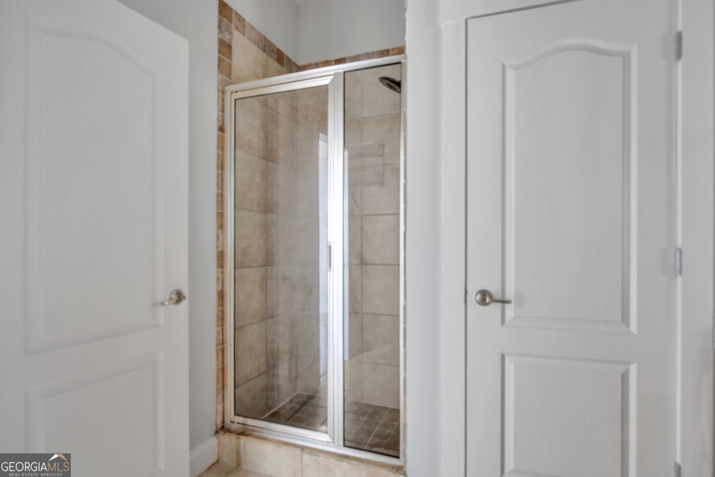 205 Ryan Lane Covington, GA 30014 - Photo 21 of 37 a bathroom with a glass shower door
