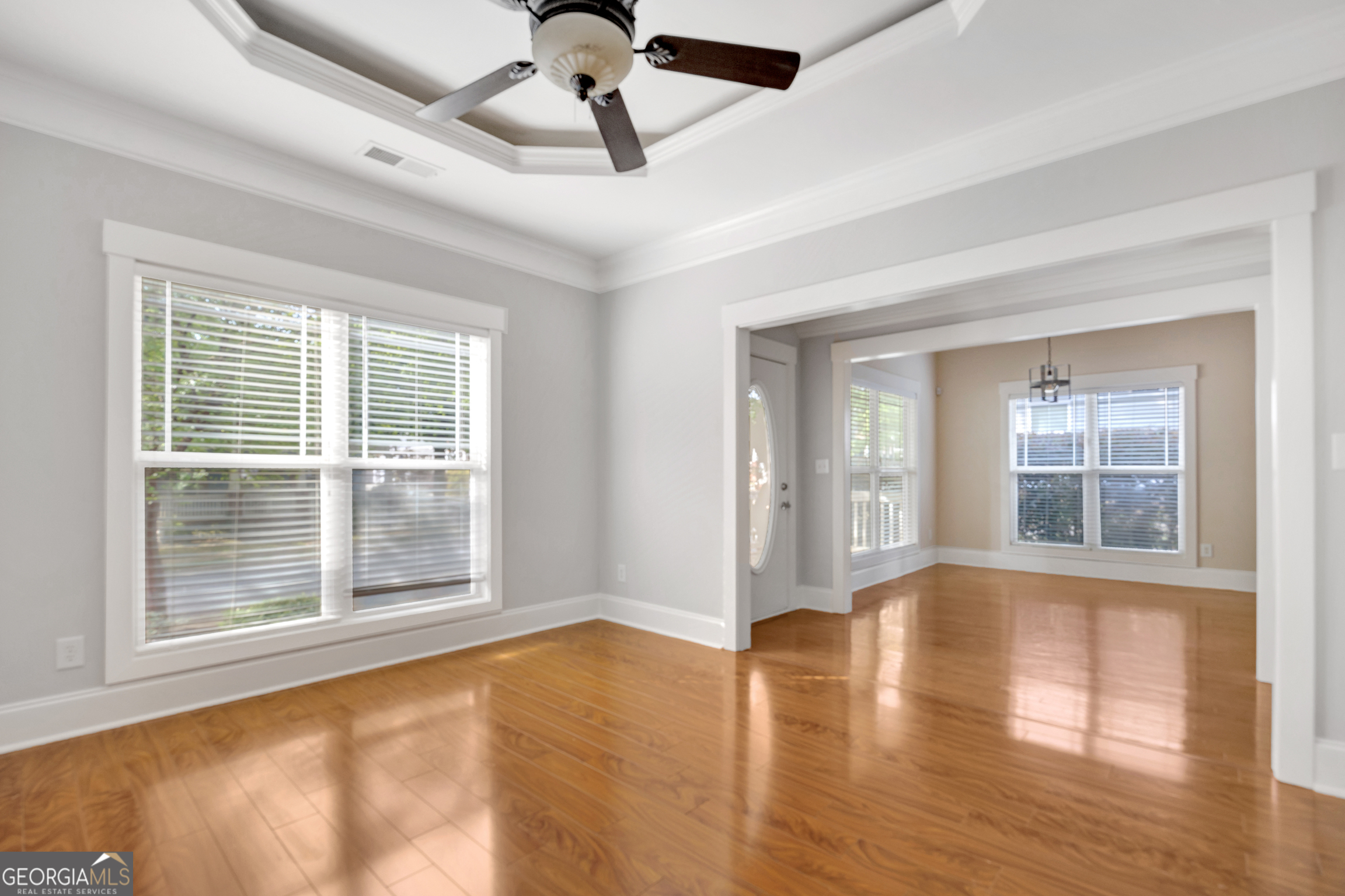 205 Ryan Lane Covington, GA 30014 - Photo 9 of 37 a view of an empty room with a window and wooden floor