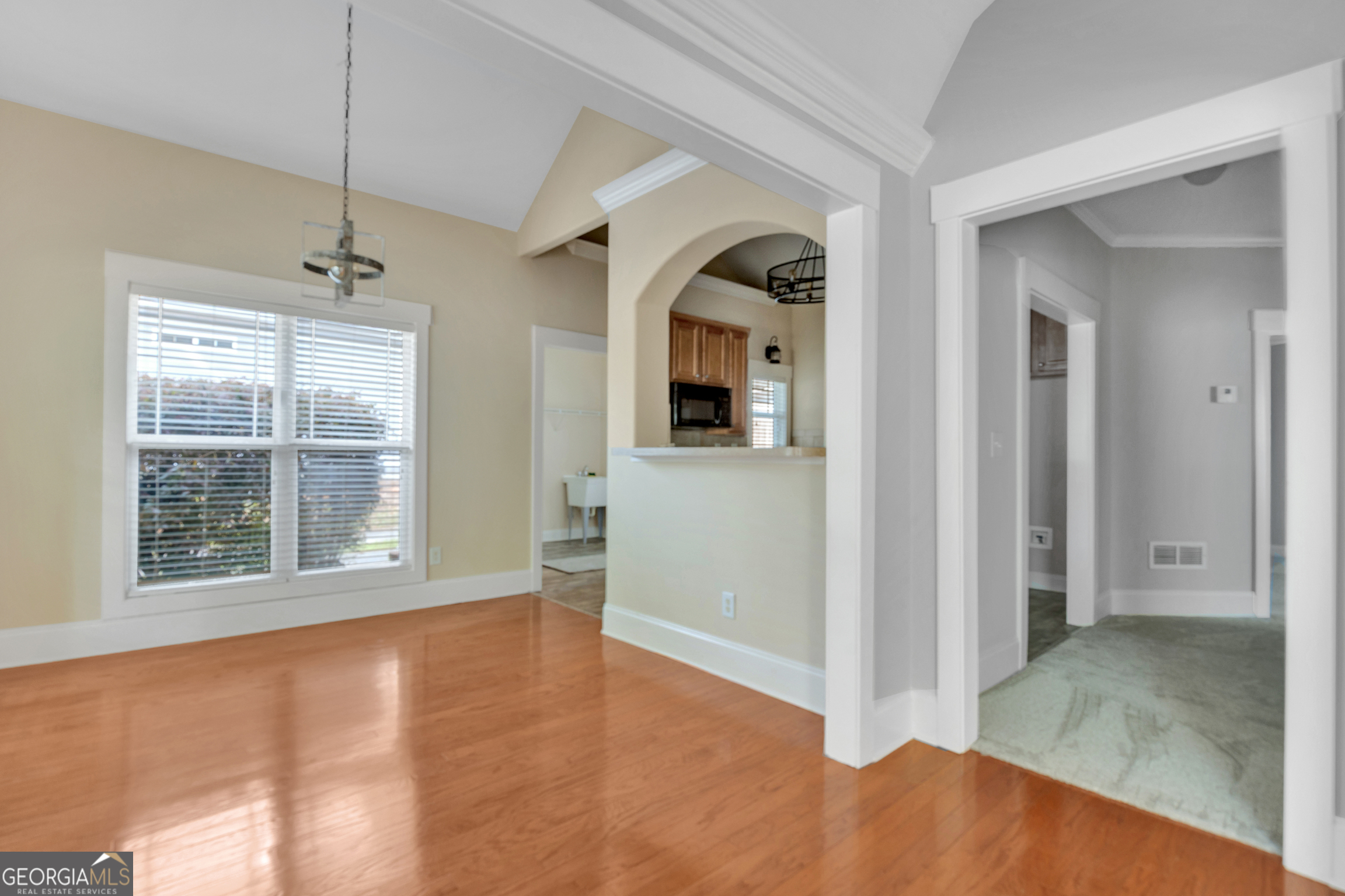 205 Ryan Lane Covington, GA 30014 - Photo 10 of 37 a view of an empty room with window and wooden floor