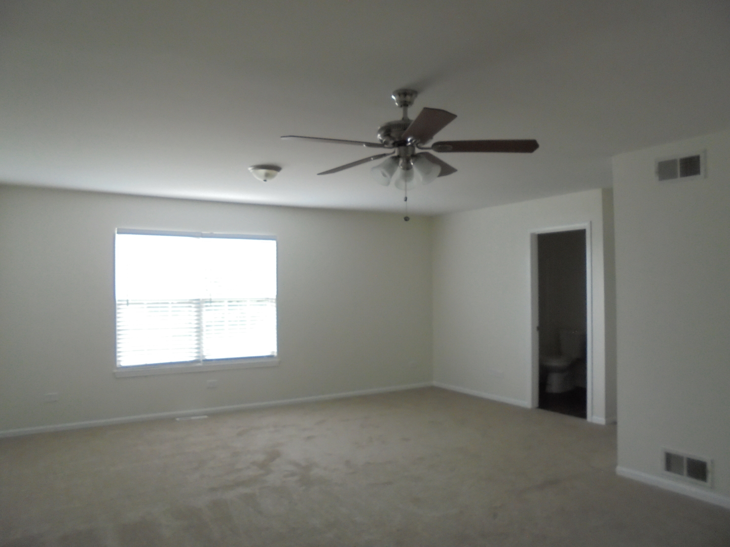 660 West Nippersink Road Round Lake, IL 60073 - Photo 19 of 24 an empty room with a window and a fan