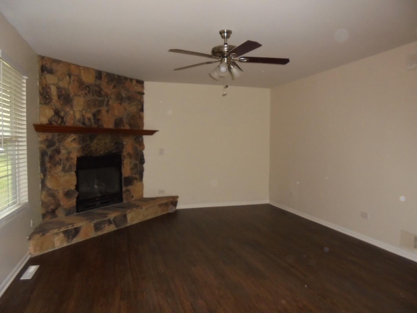 660 West Nippersink Road Round Lake, IL 60073 - Photo 5 of 24 a living room with a fireplace and a window