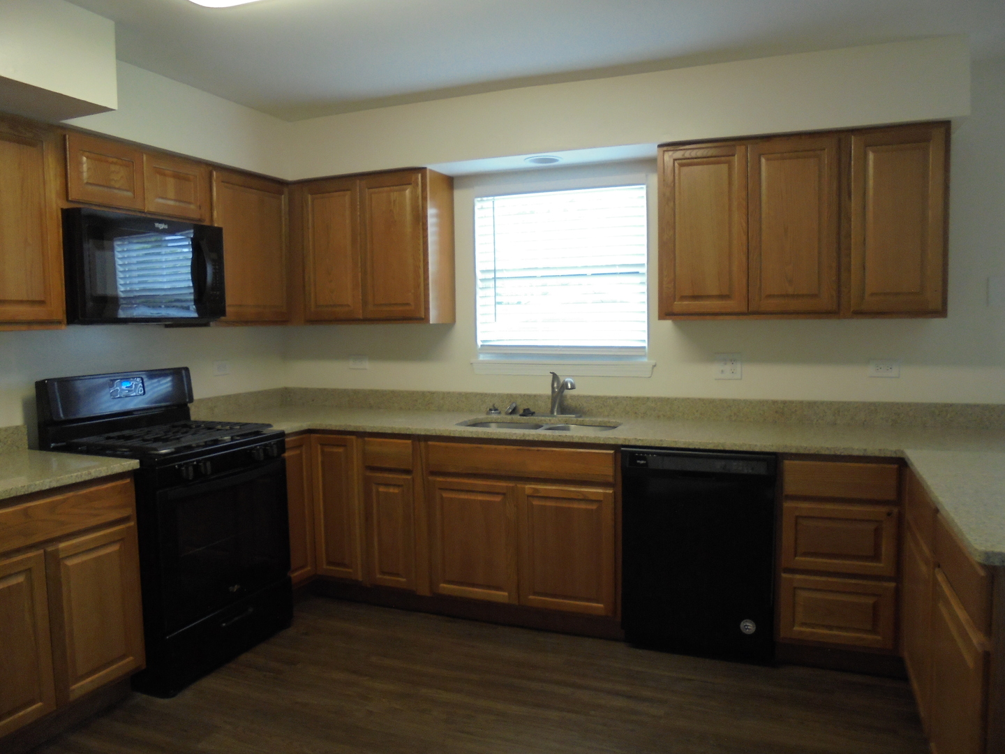 660 West Nippersink Road Round Lake, IL 60073 - Photo 7 of 24 a kitchen with granite countertop wooden cabinets a stove top oven and granite counter tops