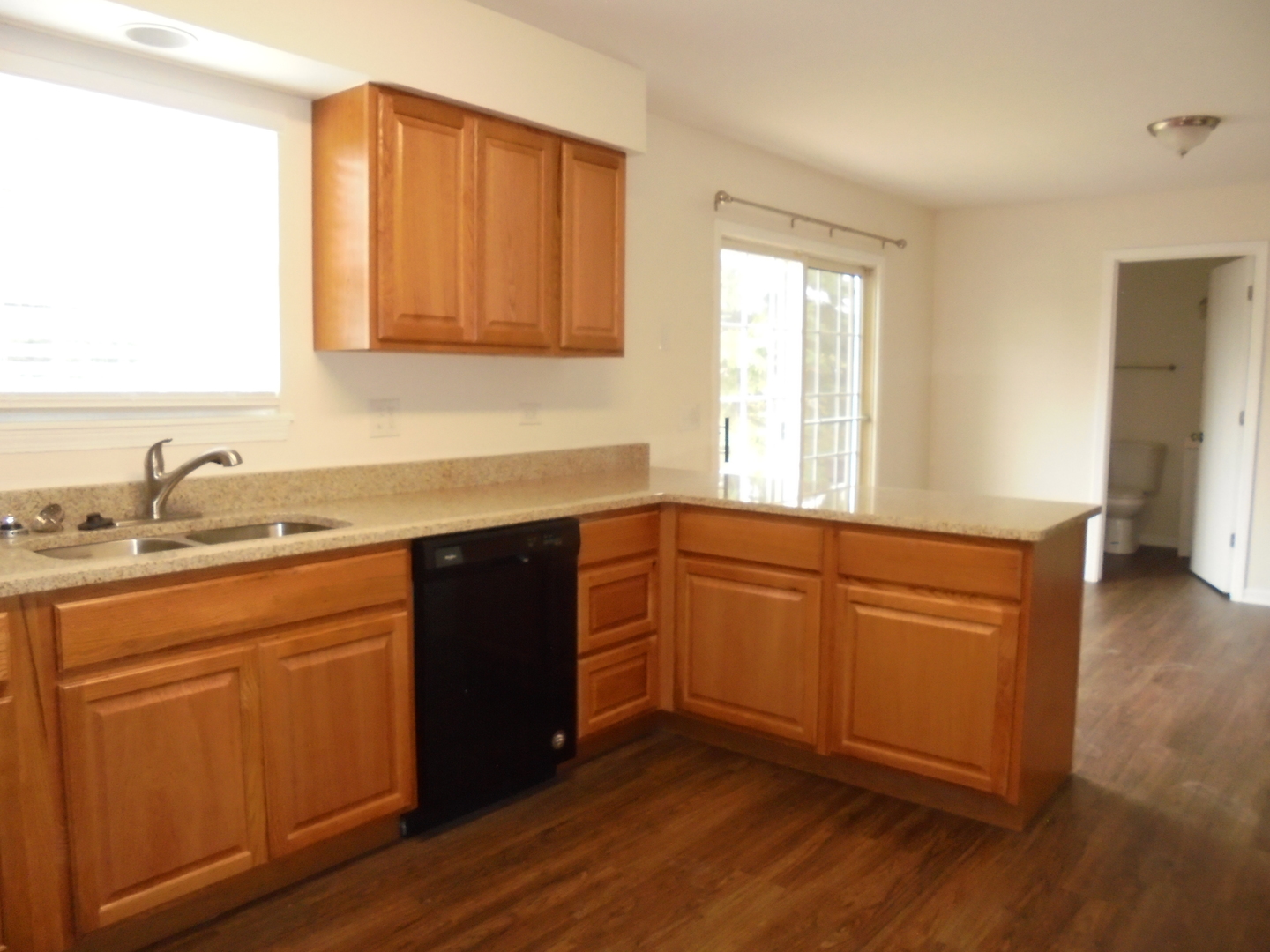 660 West Nippersink Road Round Lake, IL 60073 - Photo 8 of 24 a kitchen with stainless steel appliances granite countertop a sink a stove cabinets and wooden floor