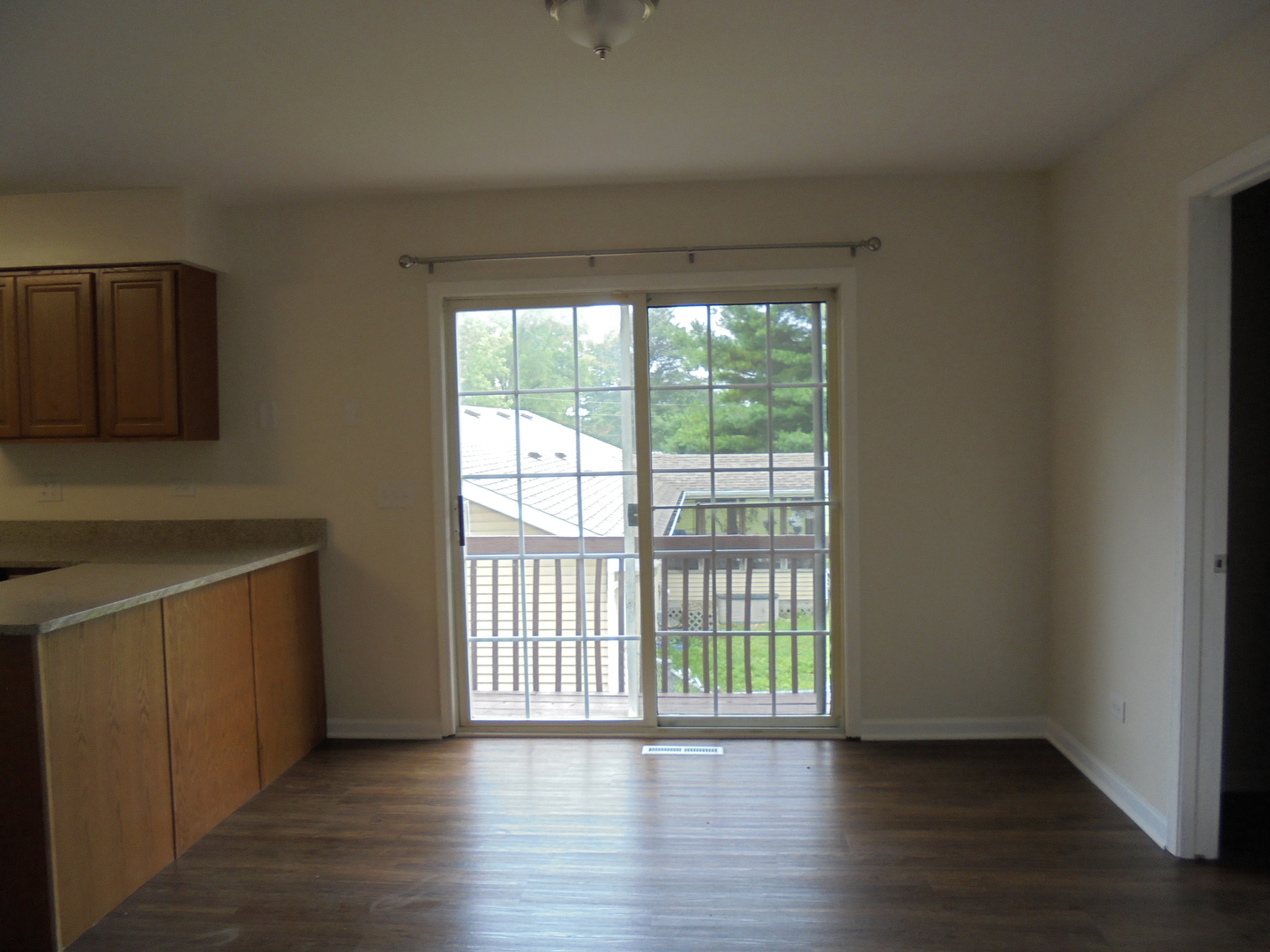 660 West Nippersink Road Round Lake, IL 60073 - Photo 9 of 24 a view of an empty room with wooden floor and a window