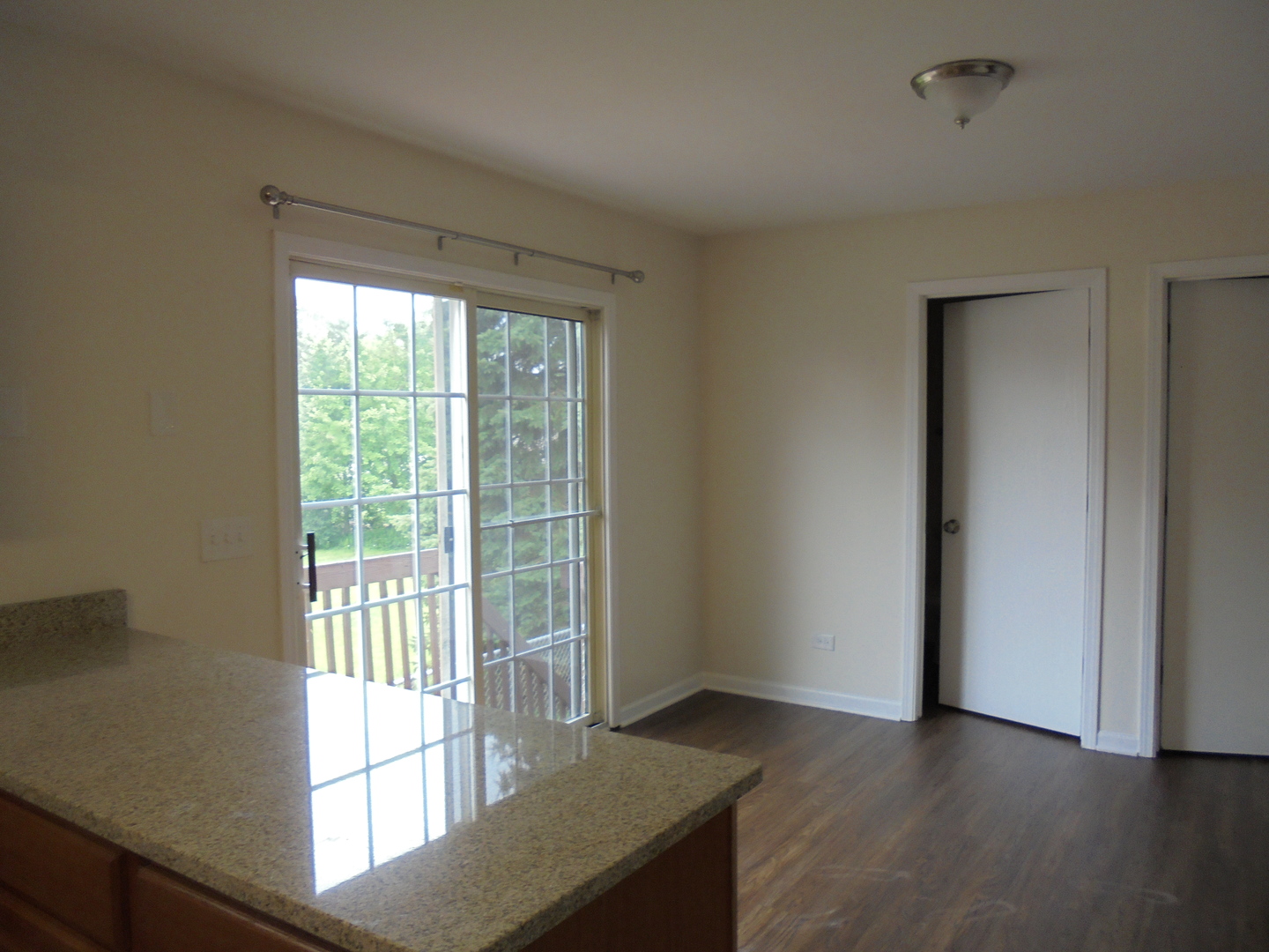 660 West Nippersink Road Round Lake, IL 60073 - Photo 10 of 24 a view of an empty room with wooden floor and a window