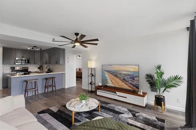 a living room with furniture potted plant and window