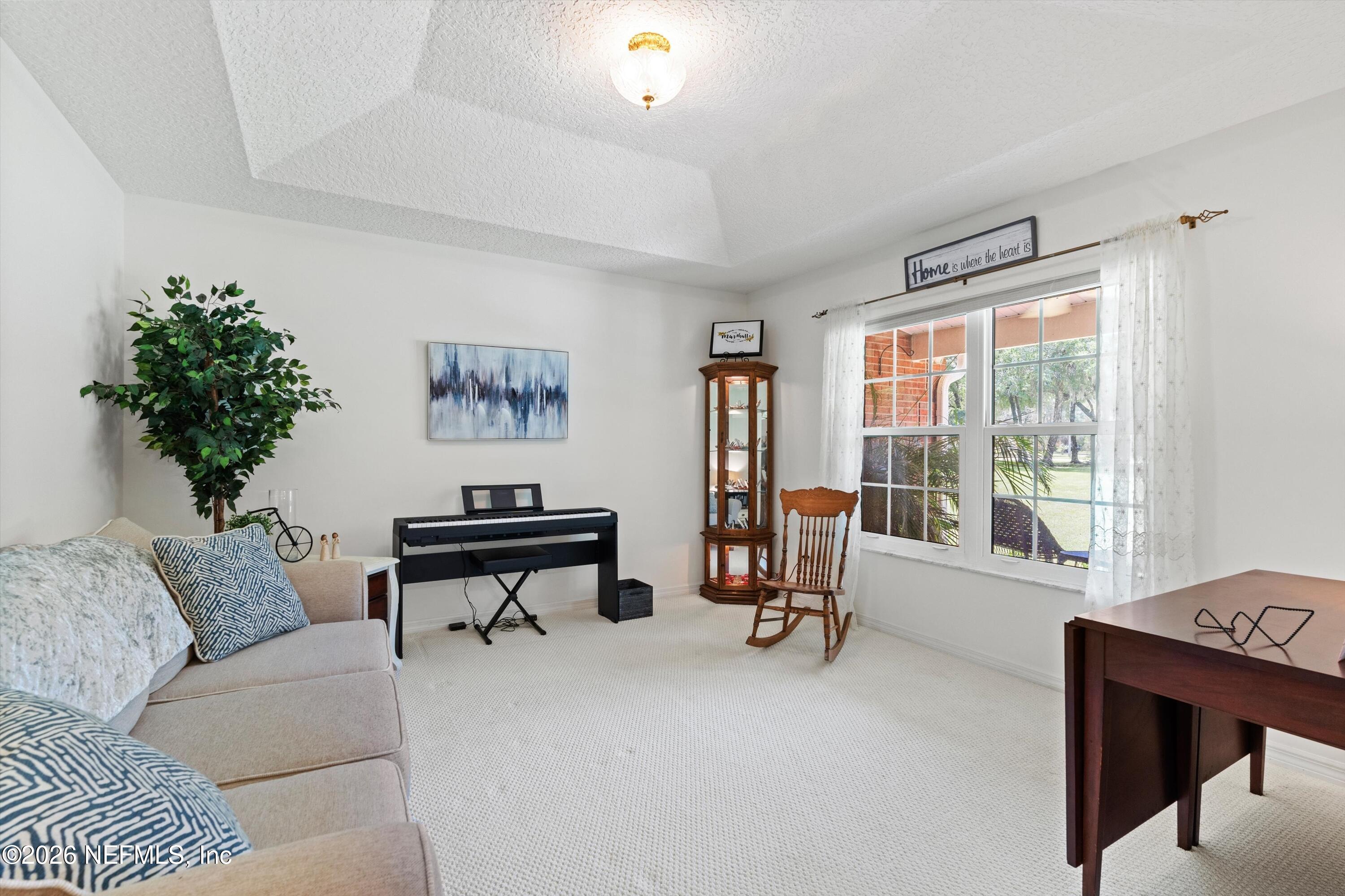 5566 Don Manuel Road Elkton, FL 32033 - Photo 7 of 47 a living room with furniture and a large window