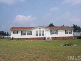 243 Oliver Loop Road Roxboro, NC 27574 - Photo 1 of 1 a front view of a house with a garden and plants