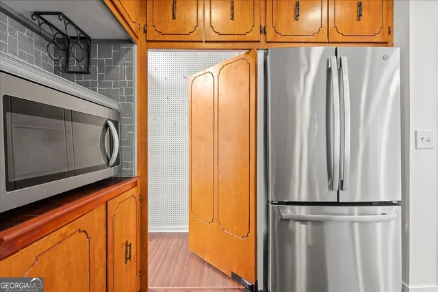 a living room with a fireplace cabinet and a fireplace