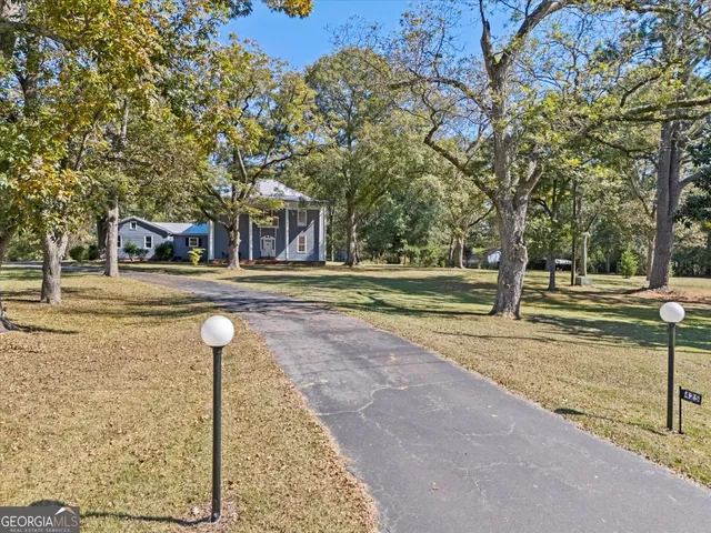 a front view of a house with a yard garage and outdoor seating