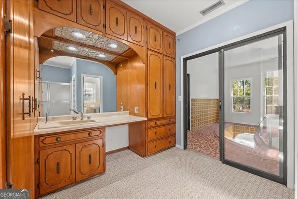 a bathroom with a toilet sink and mirror