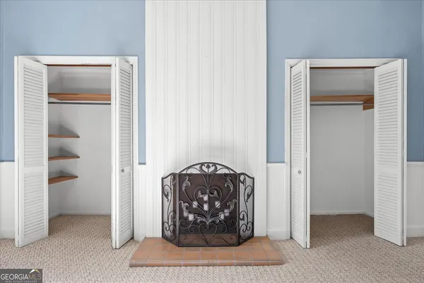 a bathroom with a toilet sink vanity and mirror