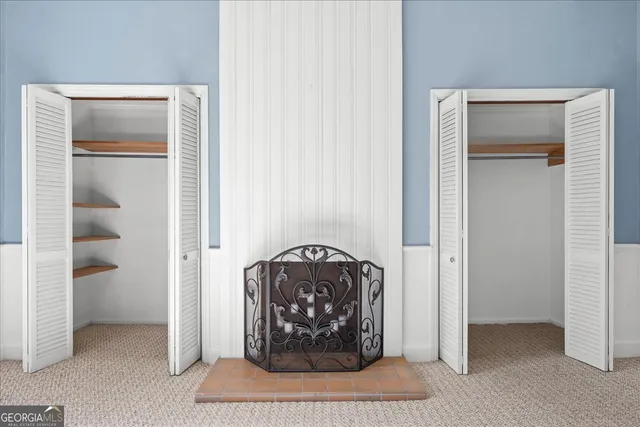 a bathroom with a toilet sink vanity and mirror