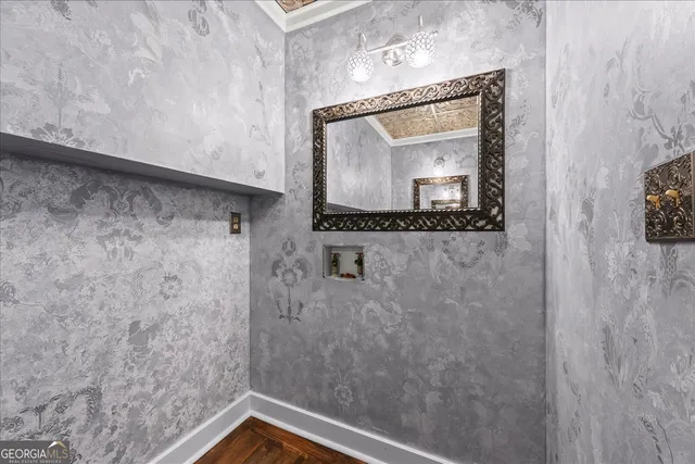 a bathroom with a granite countertop toilet a sink and a mirror