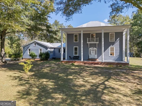 a view of patio with swimming pool and sitting area