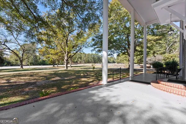 a view of empty room with wooden floor and fireplace