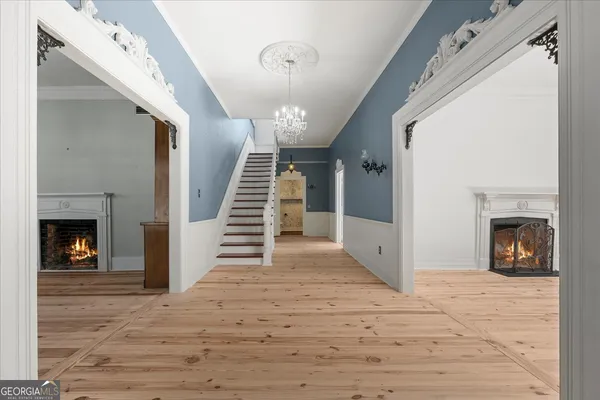 a view of empty room with wooden floor and fireplace