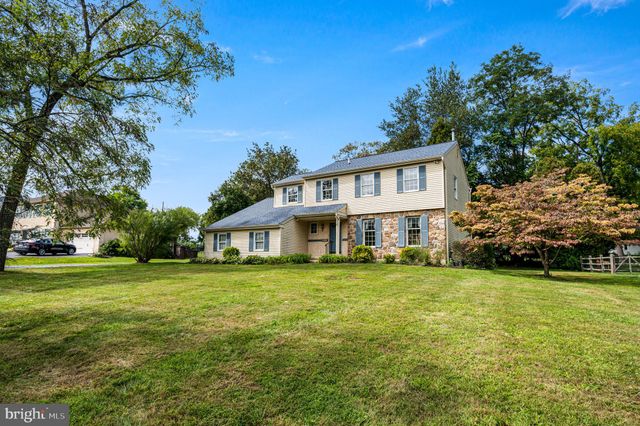 a view of a house with a big yard and large trees