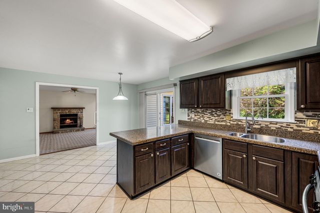 a kitchen with stainless steel appliances granite countertop a stove sink and cabinets