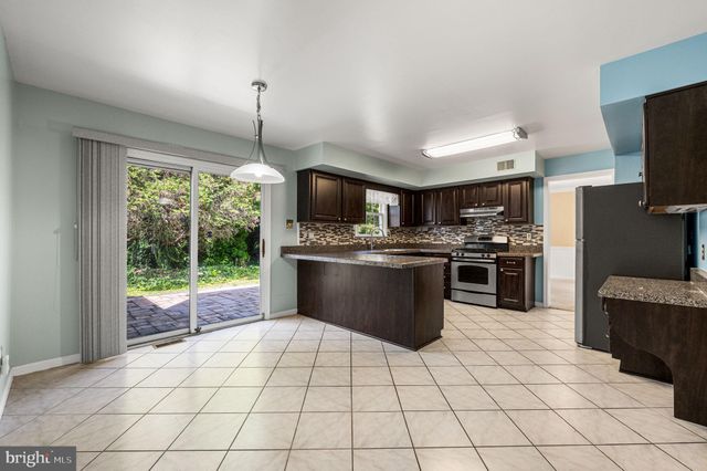 a kitchen with stainless steel appliances a stove a sink a microwave a counter top space and cabinets