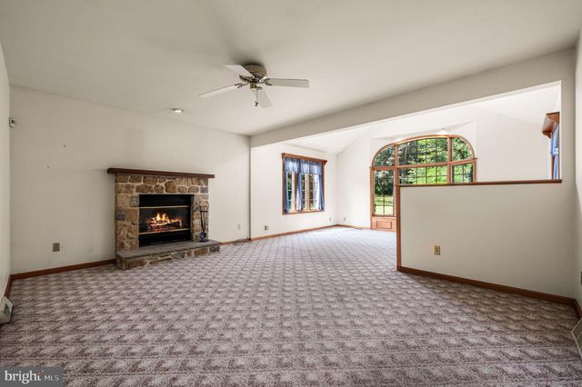 a view of empty room with a fireplace