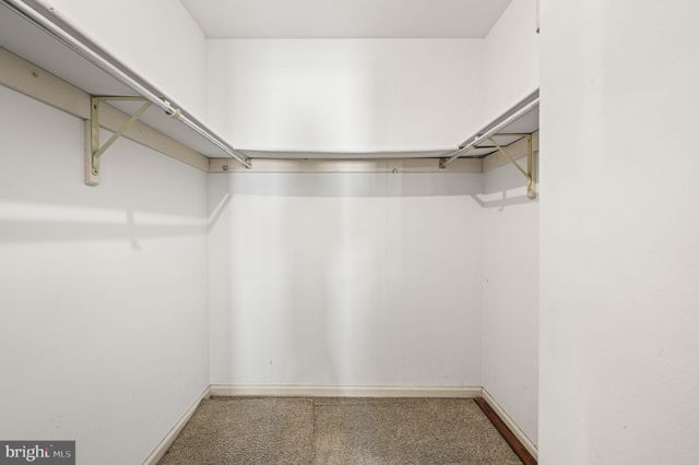 a bedroom with a bed and a potted plant