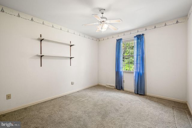 a view of a patio with a dining table and chairs with a small yard