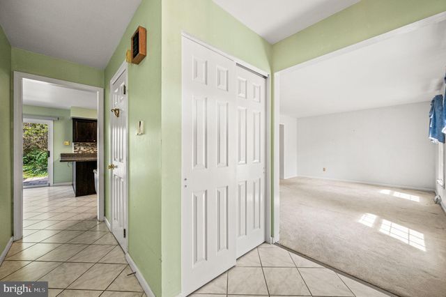 a view of a hallway with a dining table and a chair