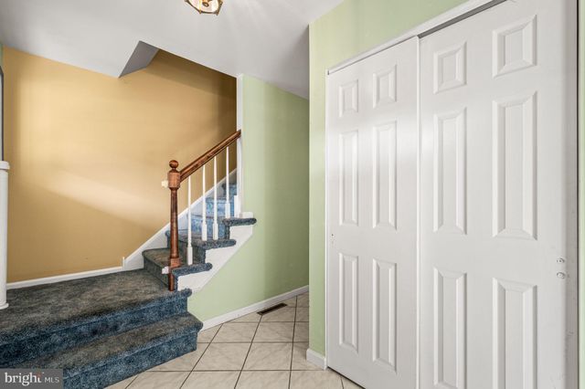 a view of entryway with wooden floor and stairs