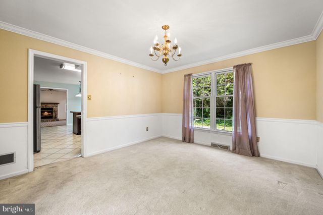 an empty room with windows and chandelier