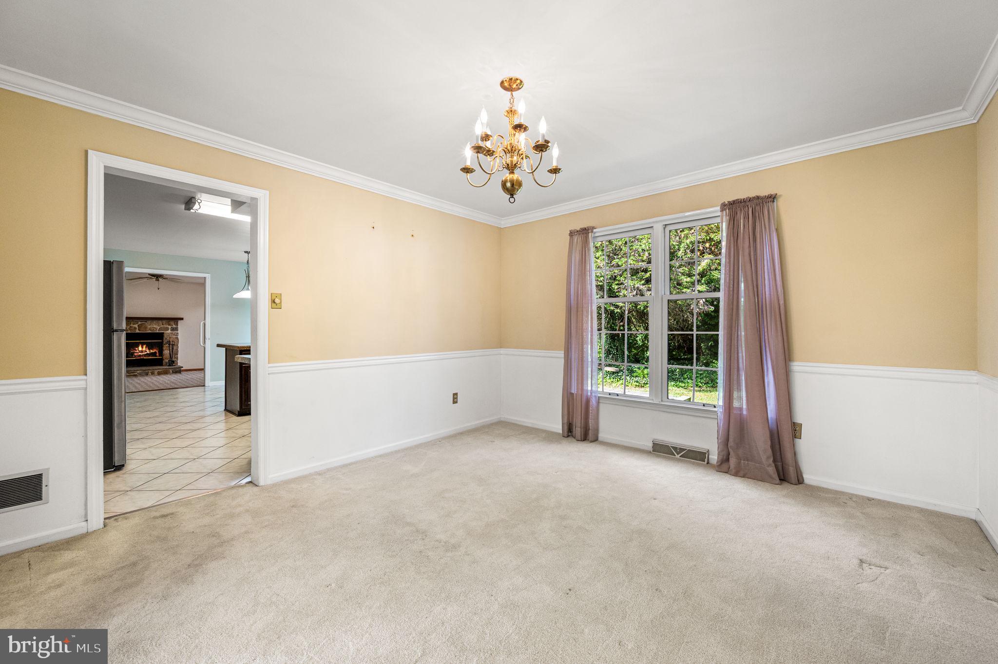 23 East Knowlton Road Media, PA 19063 - Photo 10 of 40 an empty room with windows and chandelier