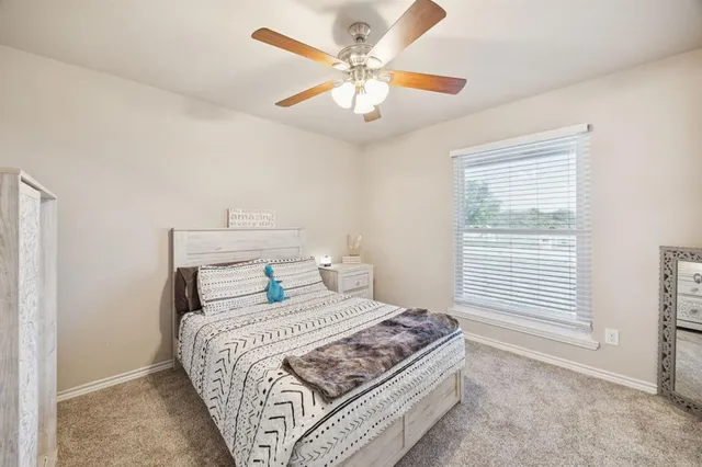 a bedroom with a large bed and a chandelier
