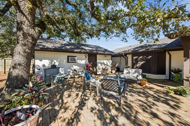a view of a patio with table and chairs and potted plants