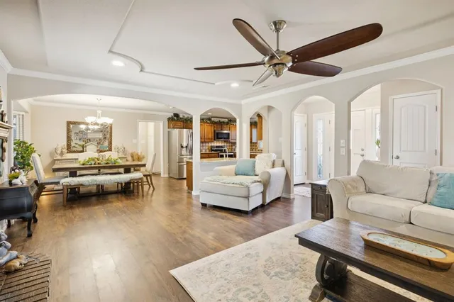 a living room with furniture and a wooden floor
