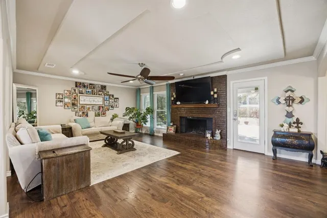 a living room with furniture a fireplace and a flat screen tv