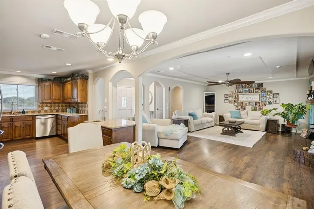 a living room with fireplace furniture and a view of kitchen