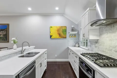 a kitchen with a sink stove and cabinets