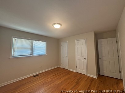 1070 Rulnick Street Fayetteville, NC 28304 - Photo 12 of 15 an empty room with wooden floor and windows