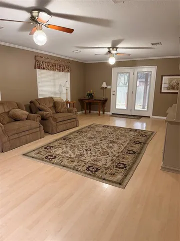 a living room with couch and a open kitchen view