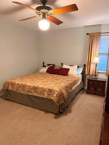 a bathroom with a toilet a sink and a window