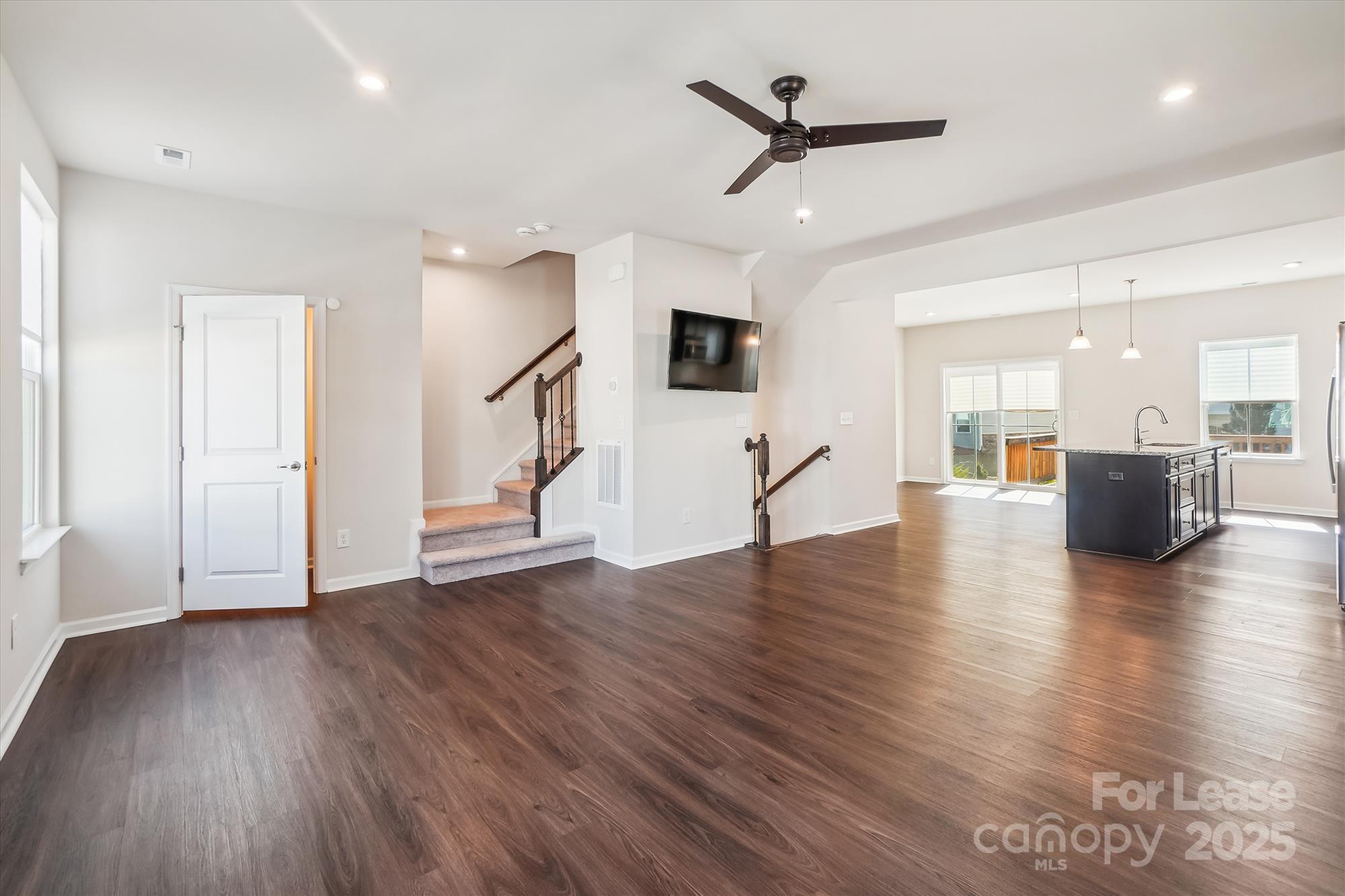 918 Portrush Lane Tega Cay, SC 29708 - Photo 16 of 36 a view of a living room a wooden floor and a ceiling fan