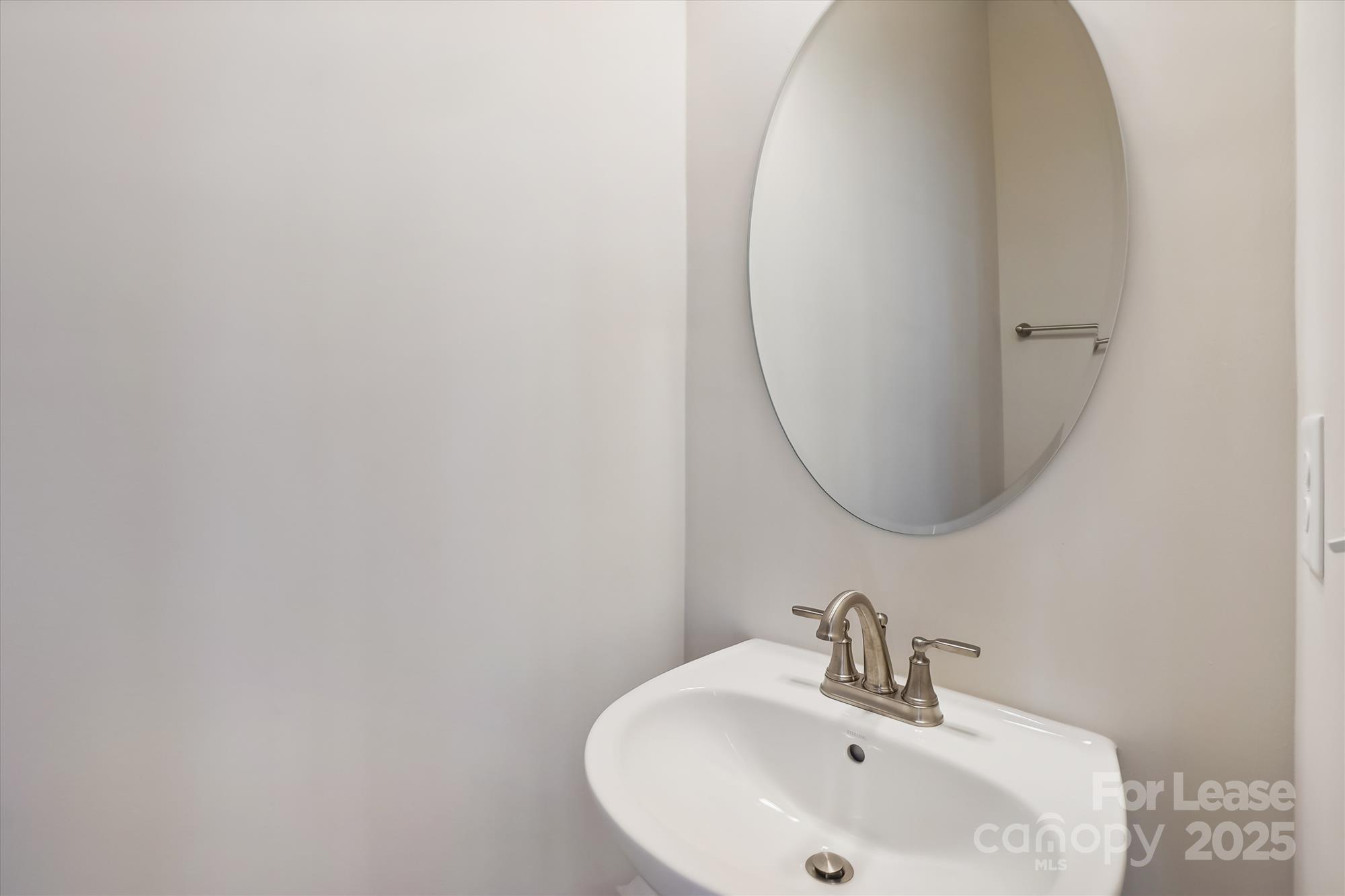 918 Portrush Lane Tega Cay, SC 29708 - Photo 17 of 36 a bathroom with a sink and a mirror