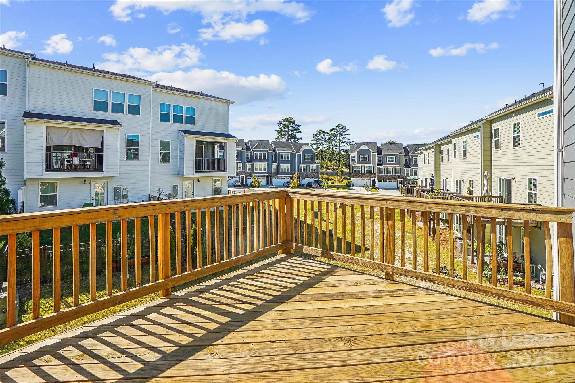 918 Portrush Lane Tega Cay, SC 29708 - Photo 18 of 36 a view of a balcony with wooden floor and city view