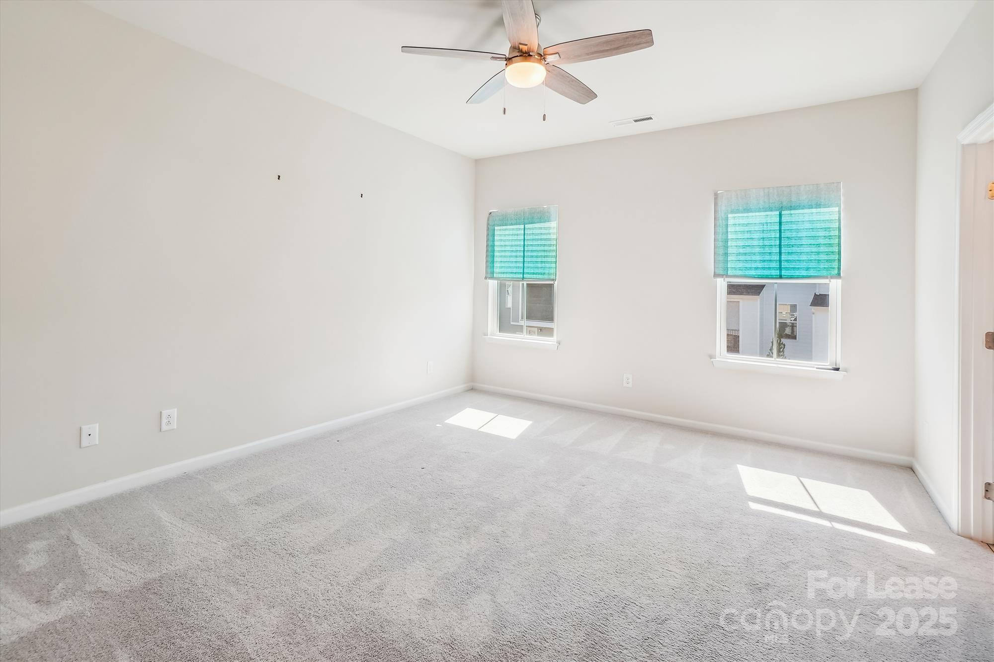 918 Portrush Lane Tega Cay, SC 29708 - Photo 28 of 36 an empty room with windows and fan
