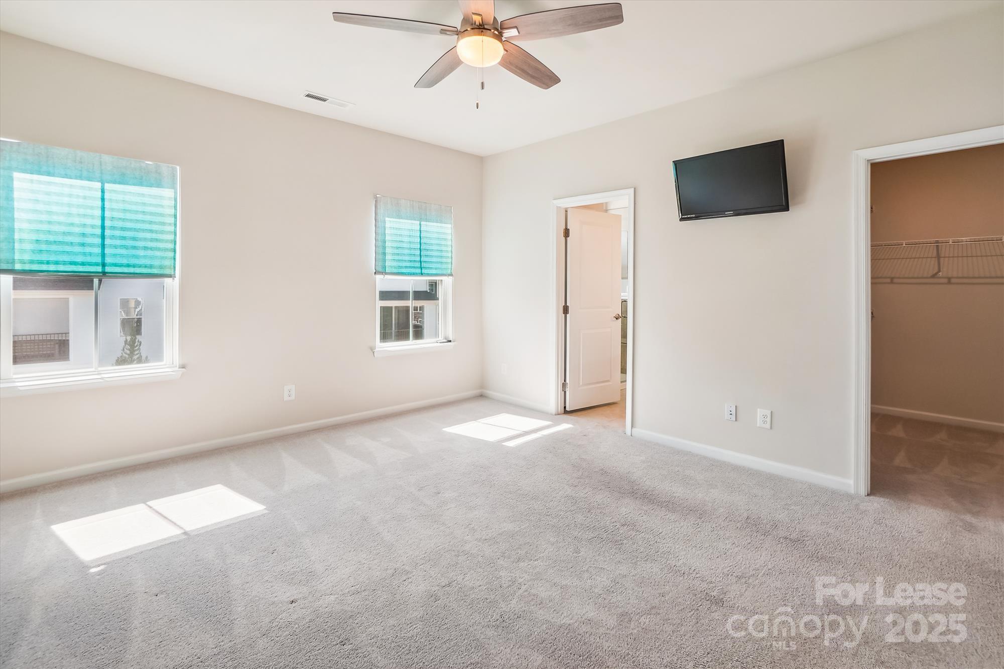 918 Portrush Lane Tega Cay, SC 29708 - Photo 29 of 36 an empty room with windows and fan